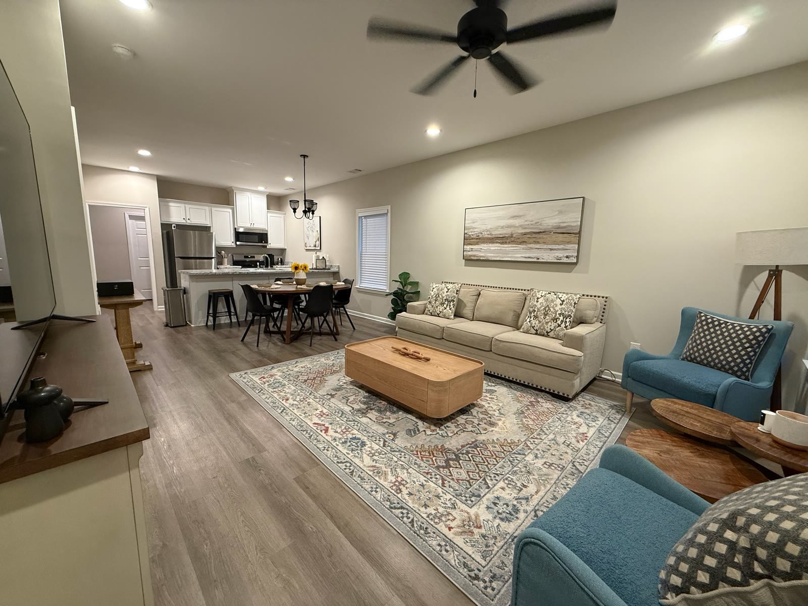 Furnished open-plan living, dining, and kitchen area
